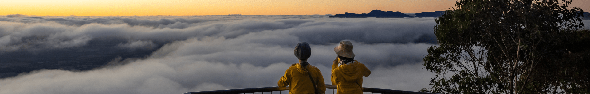 Two people looking over cloudy views