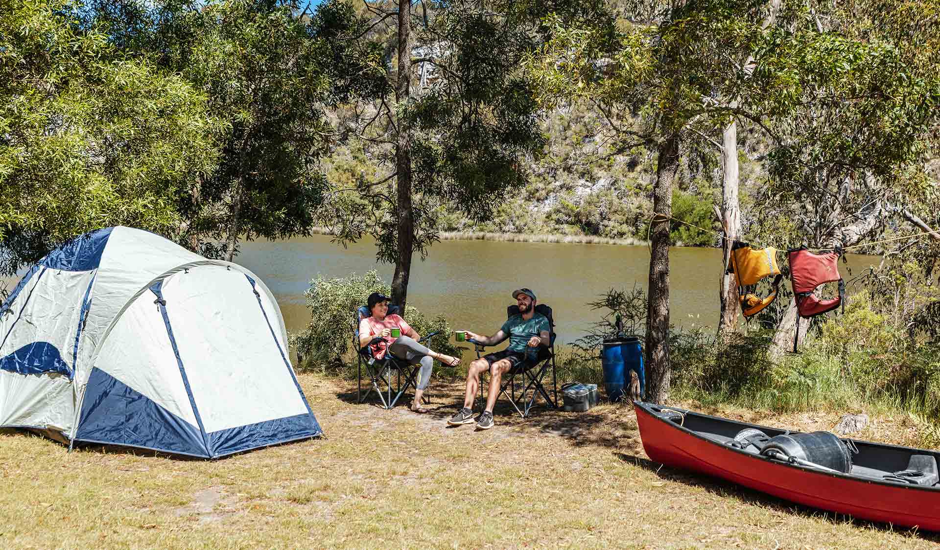Two campers relax at their campsite after a long paddle on the Glenelg River.