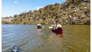 Two canoes paddle down the Glenelg River in the Lower Glenelg National Park.