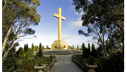 The memorial cross against a blue sky at Macedon Regional Park