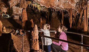 Mother and child touring a cave at Buchan Caves Reserve