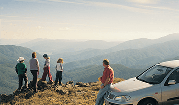 A family with their car at Mount McKay in Alpine National Park