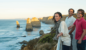 Three friends look out over the Twelve Apostles in Port Campbell National Park