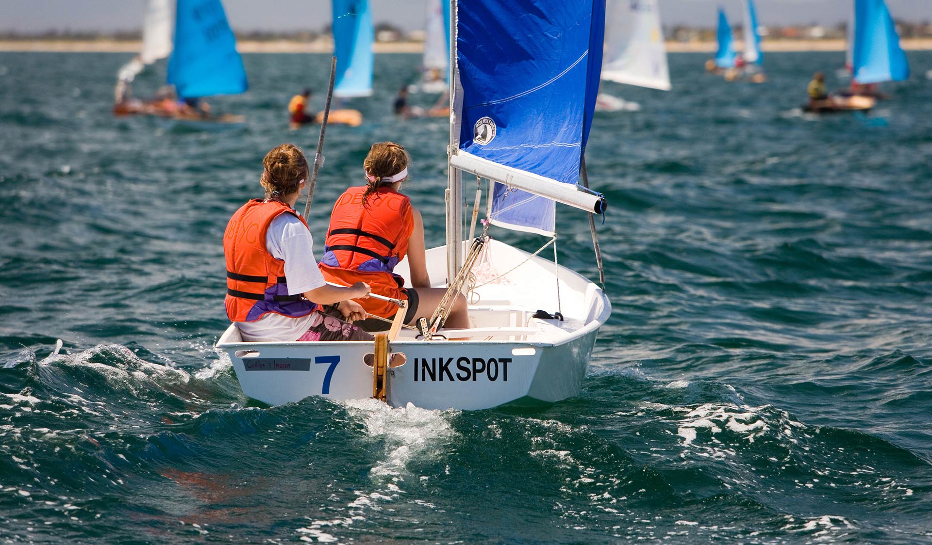 Two teenage girls take part in a sailing race on Port Philip Bay in a small boat called Inkspot. 
