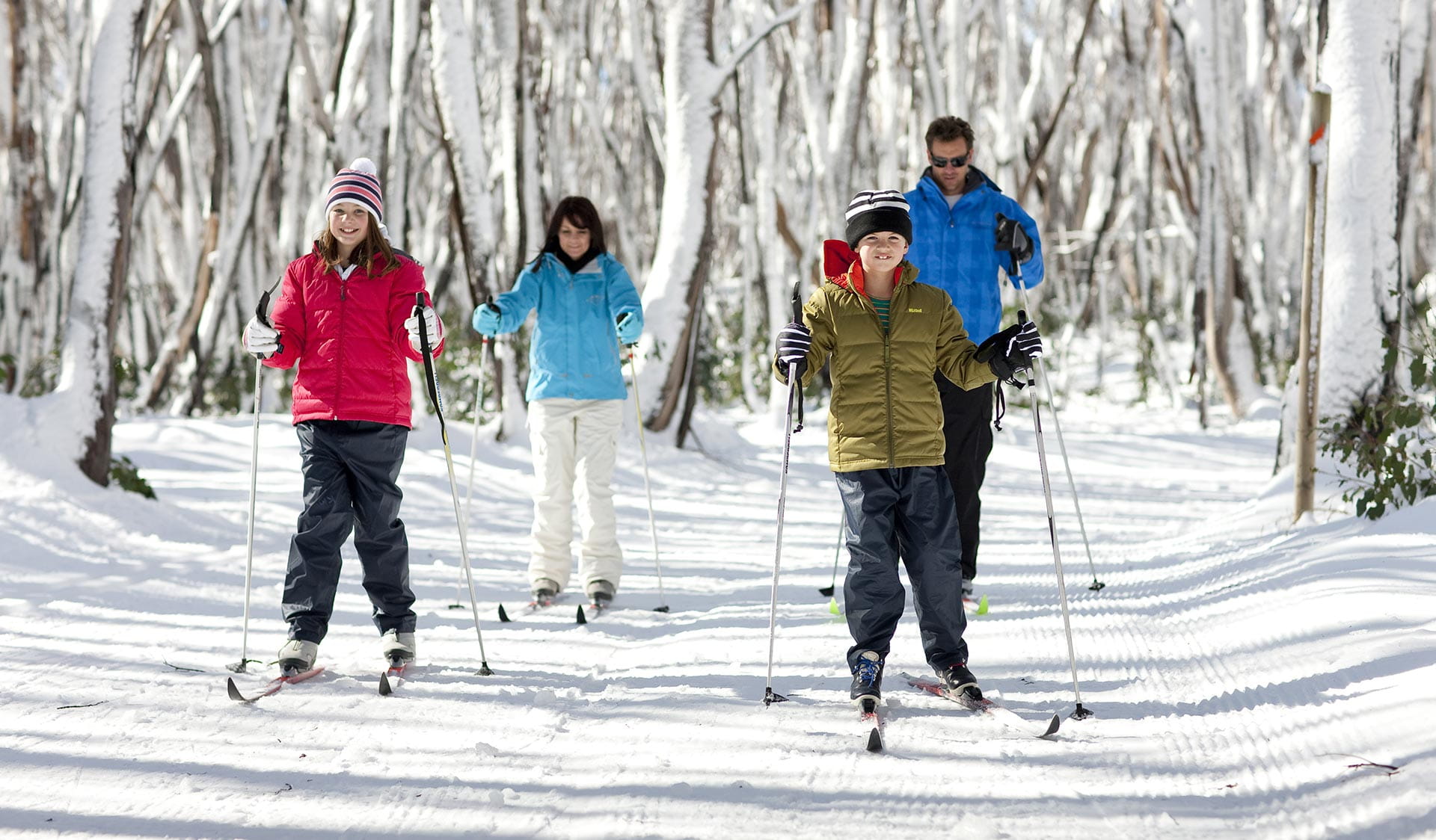 A family go cross country skiing.