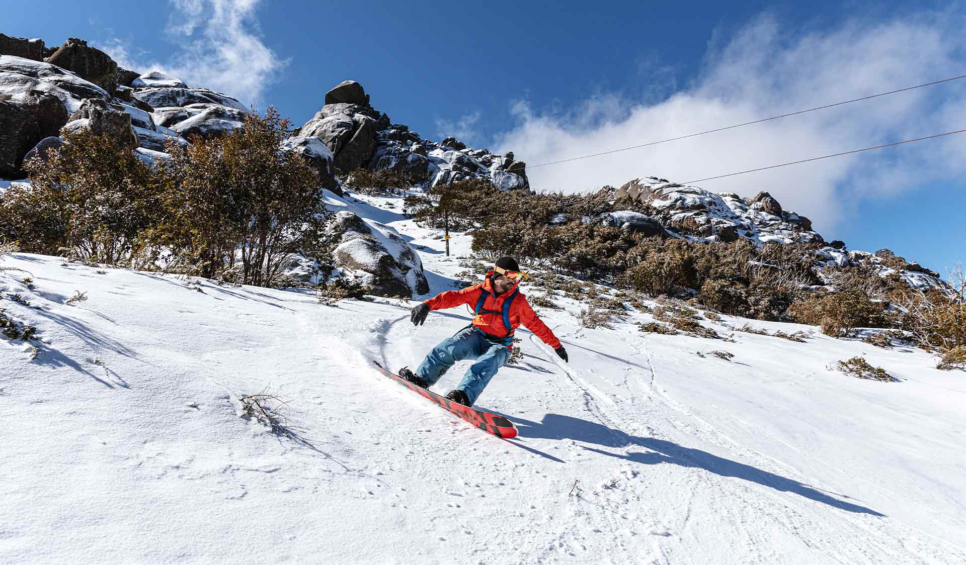 A snowboarder rides the advanced terrain in Cresta Valley at Mount Buffalo