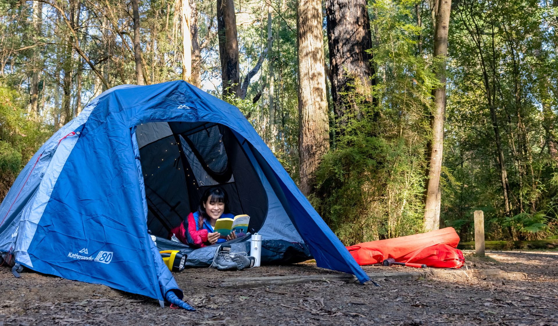 Woman inside tent on a camping trip in winter